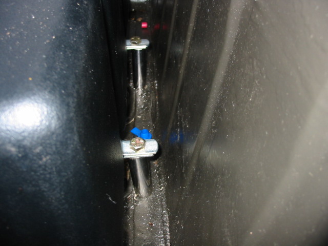 Close-up of car interior with wiring and clamps