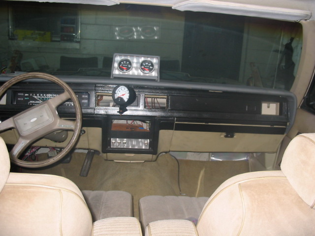 1985 Ford Crown Victoria LTD interior showing dashboard, steering wheel, and aftermarket gauges