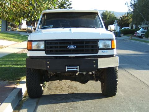 1988 Ford Bronco - This white Ford Bronco features a custom front bumper with a winch, and appears to be from the late 1980s.