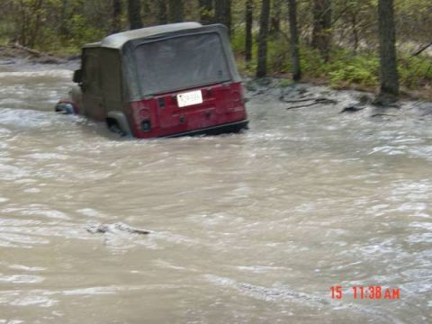 2005 Dodge 1500 - Jeep Wrangler submerged in muddy water, stuck off-road.