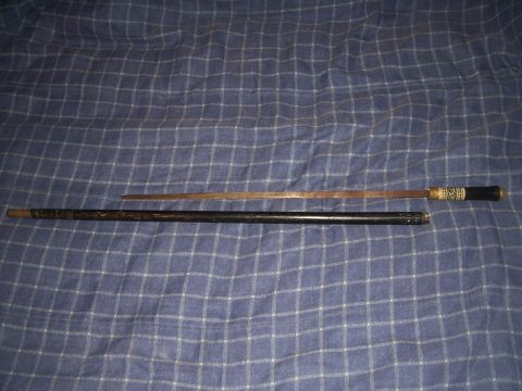 1995 Ford Bronco - A cane sword with a decorative handle is displayed on a blue checkered surface.