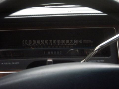 1991 Ford Crown Victoria LTD - The interior of a vehicle shows the dashboard with a speedometer and gear indicator. Text indicates 'UNLEADED FUEL ONLY'.