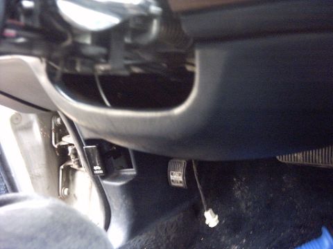 1991 Ford Crown Victoria LTD - The driver's side footwell of a vehicle, showing the brake and gas pedals, and the hood release lever.