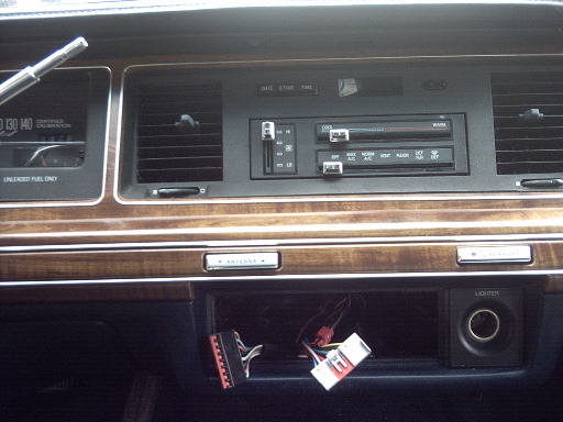 Dashboard of a 1991 Ford Crown Victoria LTD showing the radio, vents, and exposed wiring under the dash