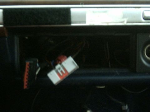 1991 Ford Crown Victoria LTD - Close-up of exposed wiring and connectors within a vehicle's dashboard compartment.