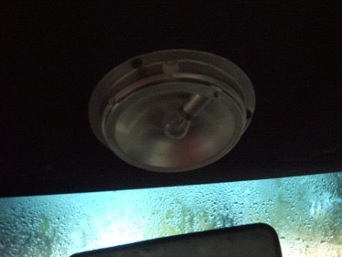 1991 Ford Crown Victoria LTD - The interior dome light is visible above a windshield covered in condensation, with a website logo in the corner.
