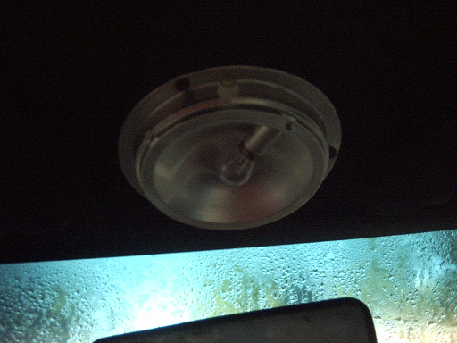Interior dome light above a condensation-covered windshield. Supermotors.net logo visible