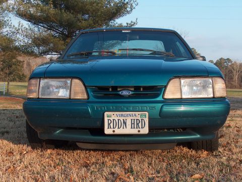 1993 Ford Mustang - Front view of a teal 1993 Ford Mustang, identified by its body style and badging.