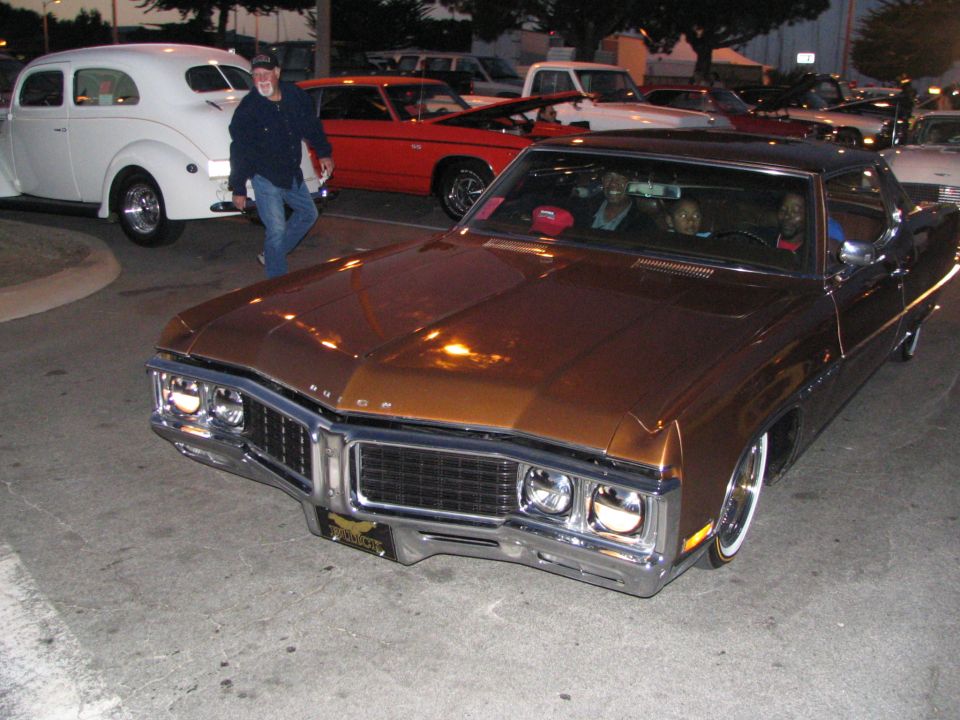 Brown 1969 Buick Riviera front 3/4 view with chrome grille and whitewall tires