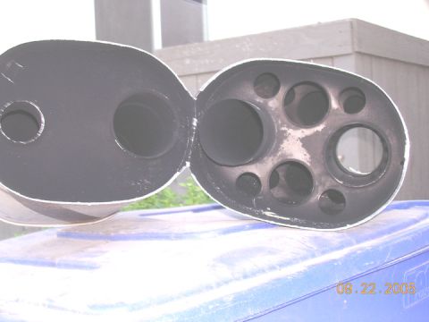 2004 Ford F-250 - The interior of a muffler delete exhaust pipe shows multiple chambers and a date stamp of 09.22.2005.