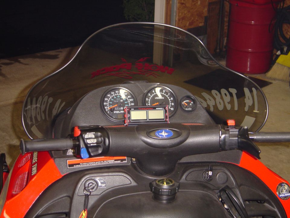 Snowmobile dashboard with two main gauges, a smaller fuel gauge, and digital display