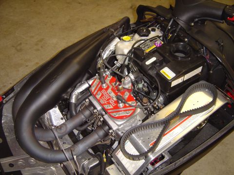 1978 Ford Bronco - Close-up view of a snowmobile's engine compartment, showing the motor and drive belt.