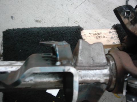 1978 Ford Bronco - A metal bracket is shown with text on a wooden block in the background.