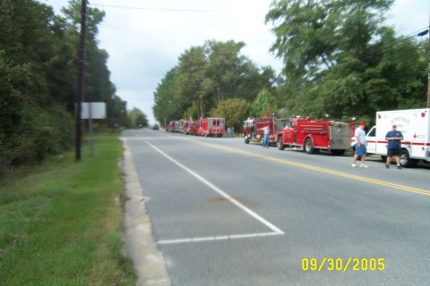 1998 Ford Crown Victoria - Emergency vehicles are parked along the road on a cloudy day in 2005.