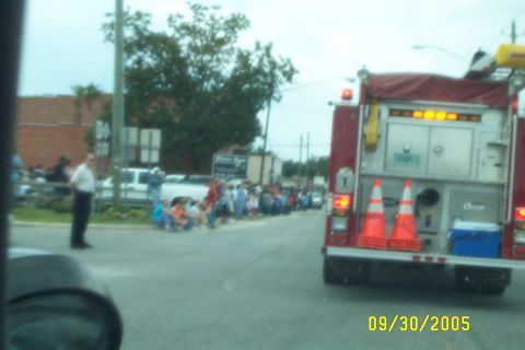1998 Ford Crown Victoria - Fire truck participates in a parade on 09/30/2005, with spectators lined up along the street.