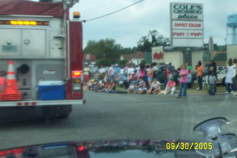 1998 Ford Crown Victoria - A crowd gathers to watch a parade, with a fire truck present. The date 09/30/2005 is visible.
