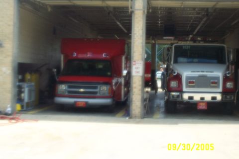 1998 Ford Crown Victoria - Two fire trucks are parked inside a garage, with a date stamp of 09/30/2005 visible in the lower right corner.
