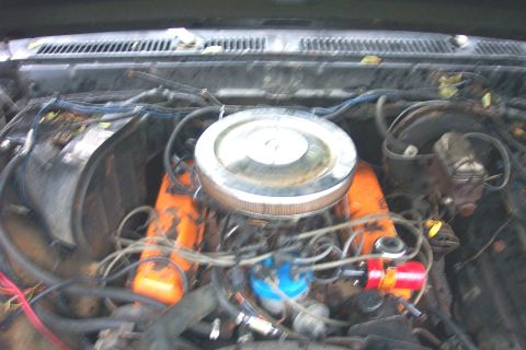 1978 Ford Bronco - The engine bay shows orange valve covers and a chrome air cleaner assembly.