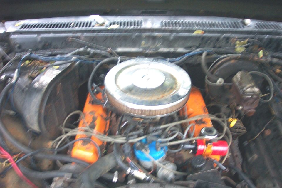 Engine bay with orange valve covers and a chrome air cleaner