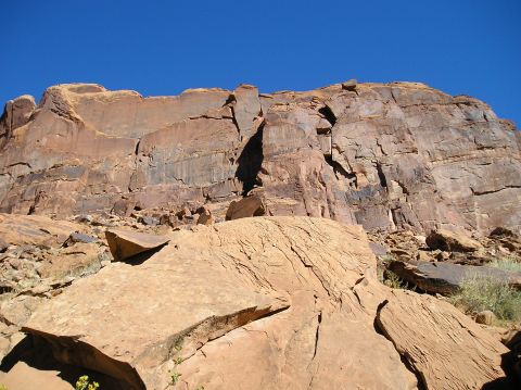 1993 Ford Bronco - A vast desert landscape under a clear blue sky, with large rock formations dominating the scene.