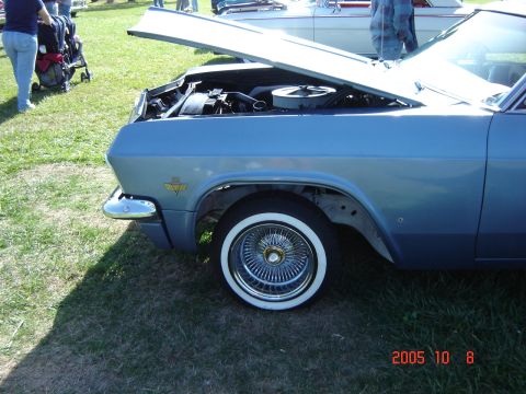 1993 Ford Bronco - Front view of a classic blue Chevrolet Impala with its hood open, revealing the engine.