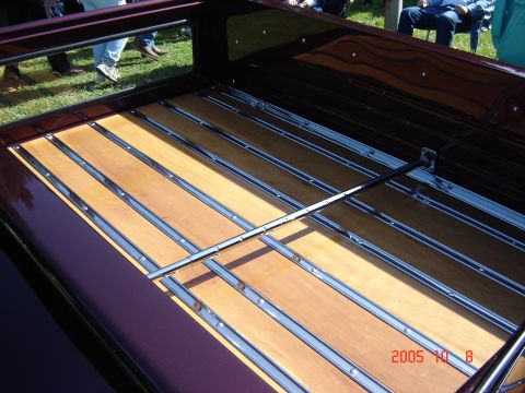 1993 Ford Bronco - The bed of a truck features a polished wood and chrome slat design.