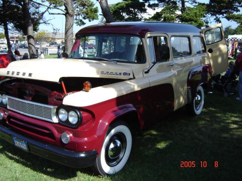 1993 Ford Bronco - This 1957 Dodge panel van is displayed outdoors with its hood open.