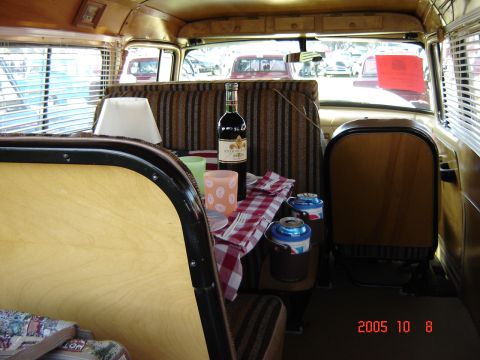 1993 Ford Bronco - A picnic setup inside a vintage vehicle, with other cars seen through the windows.
