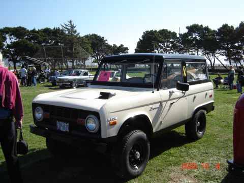 1993 Ford Bronco - A classic Ford Bronco is displayed at an outdoor car show with other vehicles present.