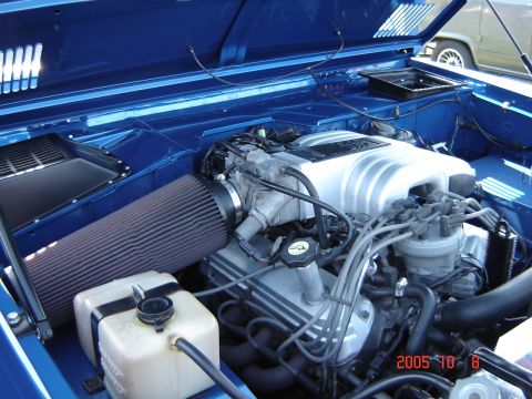 1993 Ford Bronco - Engine bay of a 1993 Ford Bronco, a V8 engine and custom blue paint.