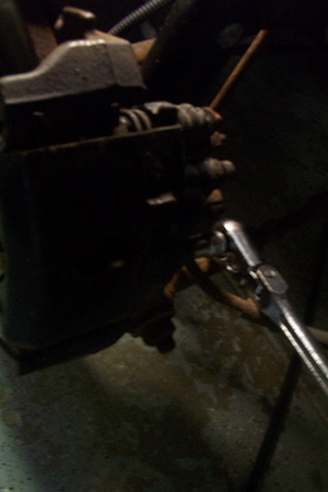 1999 Chrysler 300M - A socket wrench is used to service a disk brake caliper.