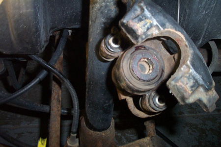 1999 Chrysler 300M - A close-up view of a worn suspension component, likely part of a vehicle's undercarriage.