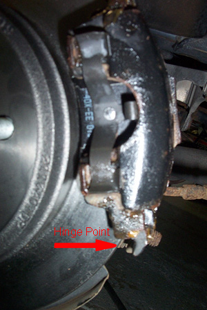 1999 Chrysler 300M - A close-up view of a vehicle's brake caliper and rotor assembly, showing wear and tear.