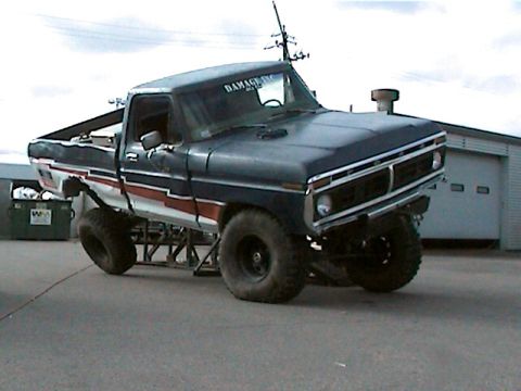 1977 Ford F-150 - This modified 1977 Ford F-150 pickup truck is displayed on a stand, showing off its custom features.