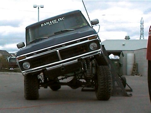 1977 Ford F-150 - This lifted Ford F-150 is angled on a ramp, revealing its undercarriage and suspension system.