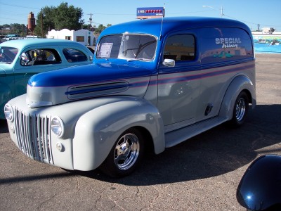 1972 Ford Ranchero - A two-tone panel van is parked outdoors, with another vehicle visible to its left.