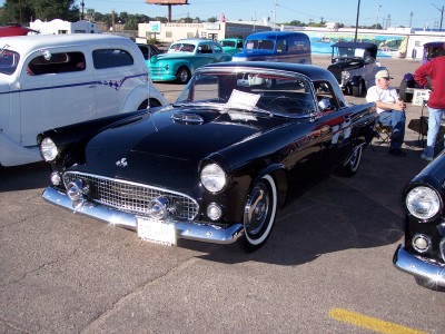 1972 Ford Ranchero - A black 1955 Ford Thunderbird is parked at an outdoor event with other classic vehicles.