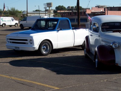 1972 Ford Ranchero - A two-tone pickup truck is parked in a lot next to another vintage vehicle.