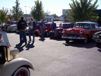 1972 Ford Ranchero - A gathering of vintage automobiles on a sunny day, with several individuals observing the vehicles.