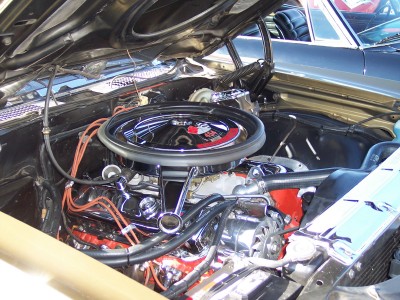 1972 Ford Ranchero - The engine bay of a 1972 Ford Ranchero shows a V8 engine with chrome accents and orange spark plug wires.