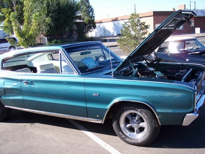 1972 Ford Ranchero - Teal 1967 Dodge Coronet parked with its hood open, showing the engine bay.