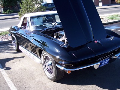 1972 Ford Ranchero - Black 1966 Corvette Sting Ray convertible, hood open, parked outdoors. White top is up.