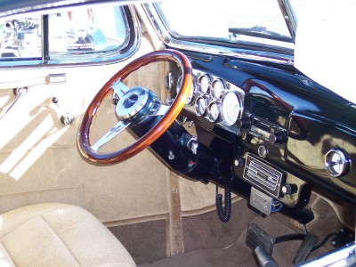 1972 Ford Ranchero - The dashboard of a classic car features a wooden steering wheel and multiple gauges.