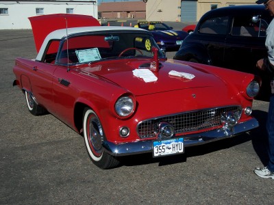 1972 Ford Ranchero - A classic red convertible is displayed with its hood up, parked next to other vehicles.