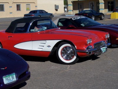 1972 Ford Ranchero - A red 1958 Chevrolet Corvette convertible is parked next to other vehicles.