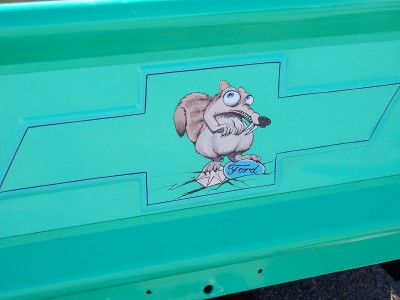 1972 Ford Ranchero - A cartoon squirrel is painted on the tailgate of a teal truck, with a Ford badge visible.
