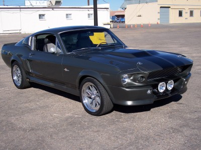 1972 Ford Ranchero - A dark gray 1967 Ford Mustang Shelby GT500 is parked outdoors on a paved surface.