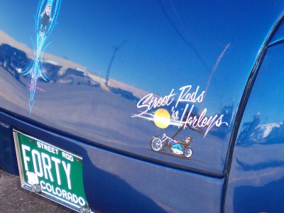 1972 Ford Ranchero - A blue car displays custom pinstriping and a sticker with a motorcycle graphic.