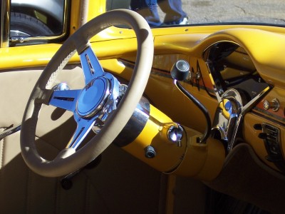 1972 Ford Ranchero - Close-up of a vintage car's interior, a custom steering wheel and bright yellow paint.