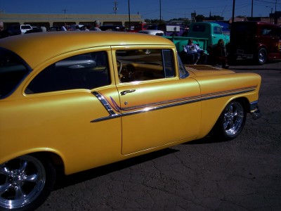 1972 Ford Ranchero - A yellow 1955 Chevrolet Bel Air coupe is parked outdoors with other vehicles in the background.